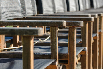 Empty wooden chairs organized in rows. The Outdoor Cafe season is over.