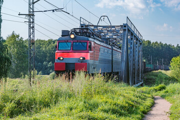 Naklejka premium Long freight train moves through the bridge.