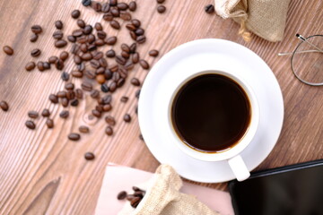 a cup of coffee on wood table and space for text