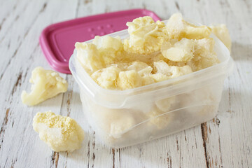 Healthy frozen food for the winter. Containers with frozen cauliflower.