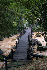 wooden bridge on river. Small rustic wooden footbridge on small river stream in the forest.