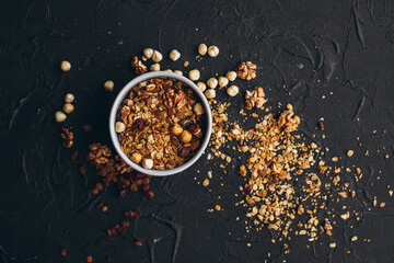 a delicious serving of granola on a dark textured table