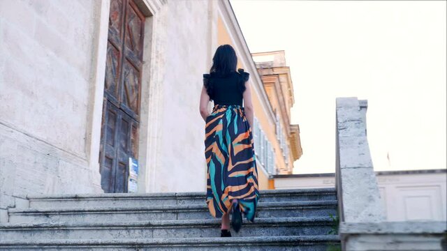 back view of elegant woman on the stairs of the terrace of the Janiculum 