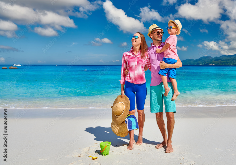 Wall mural Family with three year old boy on beach. Seychelles, Mahe.