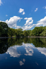 Beautiful Reflections of Clouds and Trees on the Conservatory Water Pond at Central Park during Summer in New York City