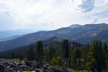 Fototapeta na wymiar Beautiful view of the Sayan mountains. Mountain range. Panoramic view. Nature of Siberia. Sense of freedom. Independent tourism.