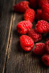 Freshly harvested raspberry on the rustic wooden background. Selective focus. Shallow depth of field.
