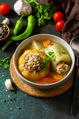 Healthy food. Bell stuffed paprika peppers with meat and bulgur in broth with vegetables. Copy space.