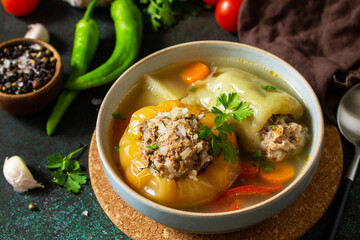 Healthy food. Bell stuffed paprika peppers with meat and bulgur in broth with vegetables.