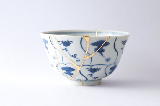 Antique Japanese ceramic kintsugi bowl restored with gold.  Antique kintsukuroi technique.