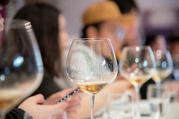 ball glass white wine on restaurant table during tasting. selective focus