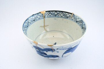 Antique Japanese ceramic kintsugi bowl restored with gold.  Antique kintsukuroi technique.