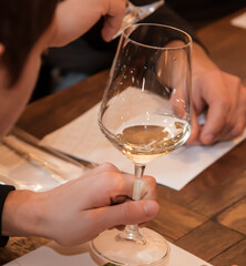 man hand with glass of white wine. wine tasting and evaluation. close-up