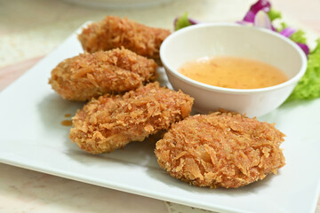 The delicious Thai Shrimps Cakes on a white plate.