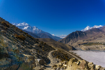 Transhimalayan landscape of Mustang in Nepal. A hiking trail to Jomsom through desert like landscape. Lower Mustang is a popular destination for adventure and religious travelers.