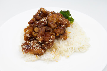 Sesame Chicken with Broccoli on a White Plate with a White Background 
