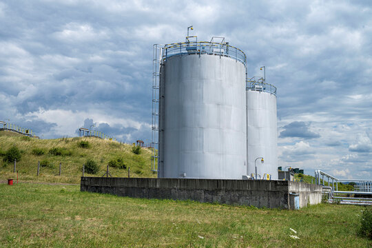 Two Petrochemical Tanks On The Fuel Base With Underground Tanks On The Background, Europe