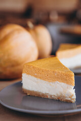 Slices of Freshly Baked Pumpkin Pie on cozy cafe background, selective focus, noise effect