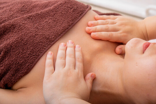 woman getting shoulder massage, thai therapist touching chest