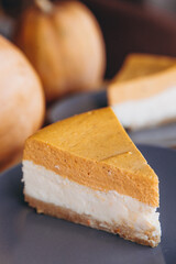 Piece of pumpkin homemade cake. Festive dessert concept. pumpkin tart on cozy cafe background, selective focus, noise effect