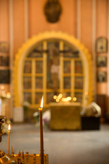 The interior of the Russian Christian church. Candles and icons during the service. Chesme church in the city of St. Petersburg, Russia. Image with selective focus.