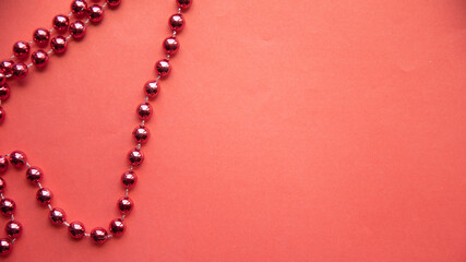 red Christmas decoration (chain) on a red background