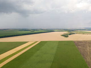 Aerila drone view. Summer rain over agricultural fields in Ukraine.
