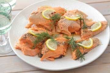 Baked trout served with lemon and dill