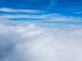 Fototapeta premium High flight in white curly clouds.