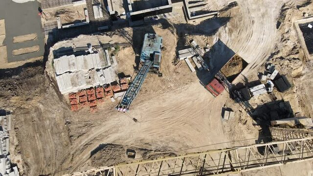 Large construction of a residential complex. Truck with sand. Top to bottom view. Aerial view.