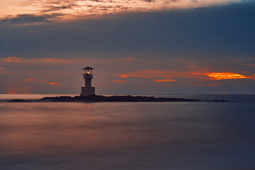 Seascape at sunset. Lighthouse on the coast. long shutter shot