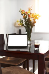 Home freelance desktop with open laptop computer, cup of coffee, business person net-book with blank screen for information content or text message