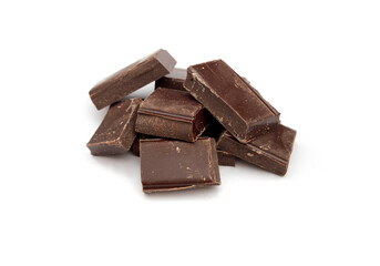 Few small pieces of dark chocolate isolated on white. Studio shot. Nobody