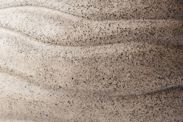 Beige background made of clay with applied pattern. Natural texture.