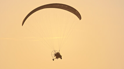 Paramotor Tandem Gliding And Flying In The Air. Copy space. High quality photo