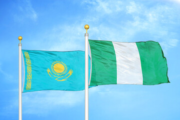 Kazakhstan and Nigeria two flags on flagpoles and blue sky