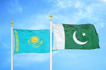 Kazakhstan and Pakistan two flags on flagpoles and blue sky