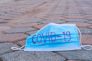 The medical masks used for the protection against COVID-19 left on the road. 