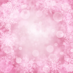 Christmas background of blurry snowflakes in pink colors