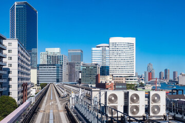 Obraz premium Japan. Railway in Tokyo. Railroad overpass view from above. Railways are located next to skyscrapers. Road architecture in Japan. Tokyo cityscape. Tokyo on the background of blue sky.