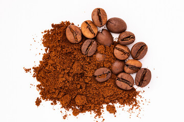 Heap coffee beans and ground coffee close up isolated on white