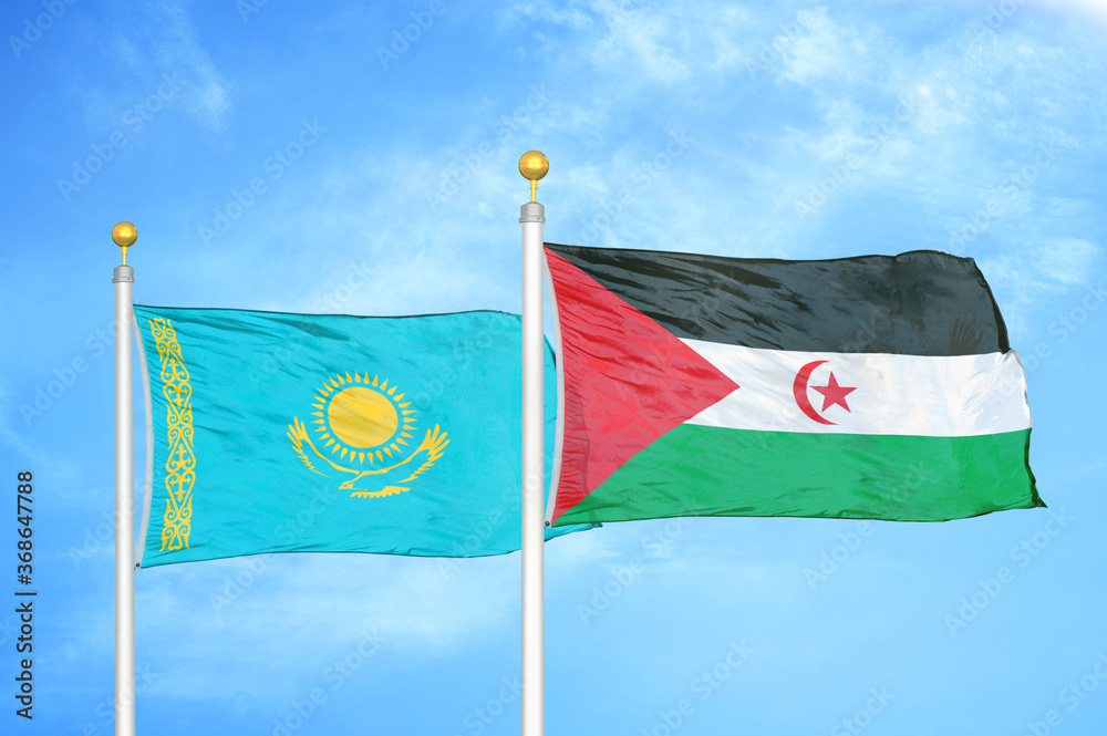 Wall mural kazakhstan and western sahara two flags on flagpoles and blue sky