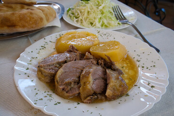 Traditional Balkan dish - meat stewed in a special pot, sac, and served with kajmak cheese and stewed vegetables
