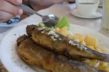 The traditional dish of Eastern Serbia - grilled mountain trout with garlic, lemon, parsley and olive oil
