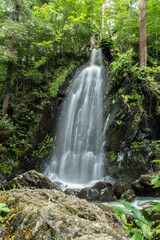 Fototapeta na wymiar Beautiful waterfall in the forest in pure nature