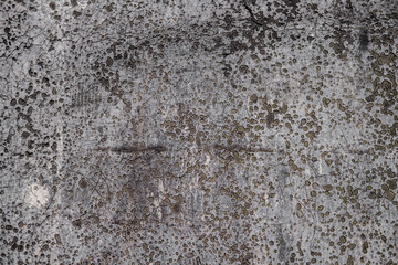 Dirty and worn background from an old leaky roofing material, with a large number of small depressions and scratches.