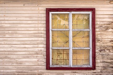 Old wooden window with metal grid