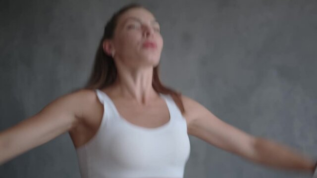 A sports trainer with muscles jumps on a home mini trampoline