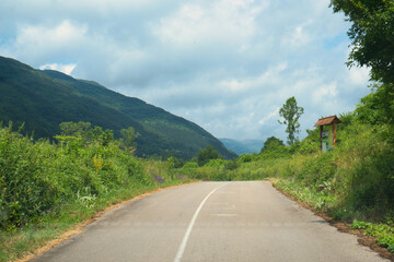 Scenic asphalt countryside road in beautiful mountain valley of Stara Planina on a rainy day