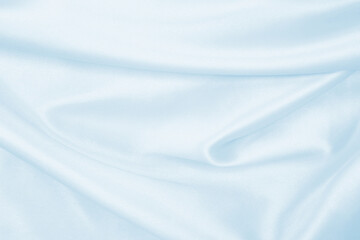 Smooth elegant blue silk or satin luxury cloth texture as abstract background. Luxurious background design
